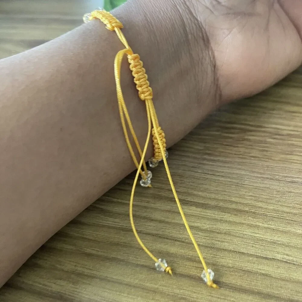 Yellow women's bracelet braided with crystals